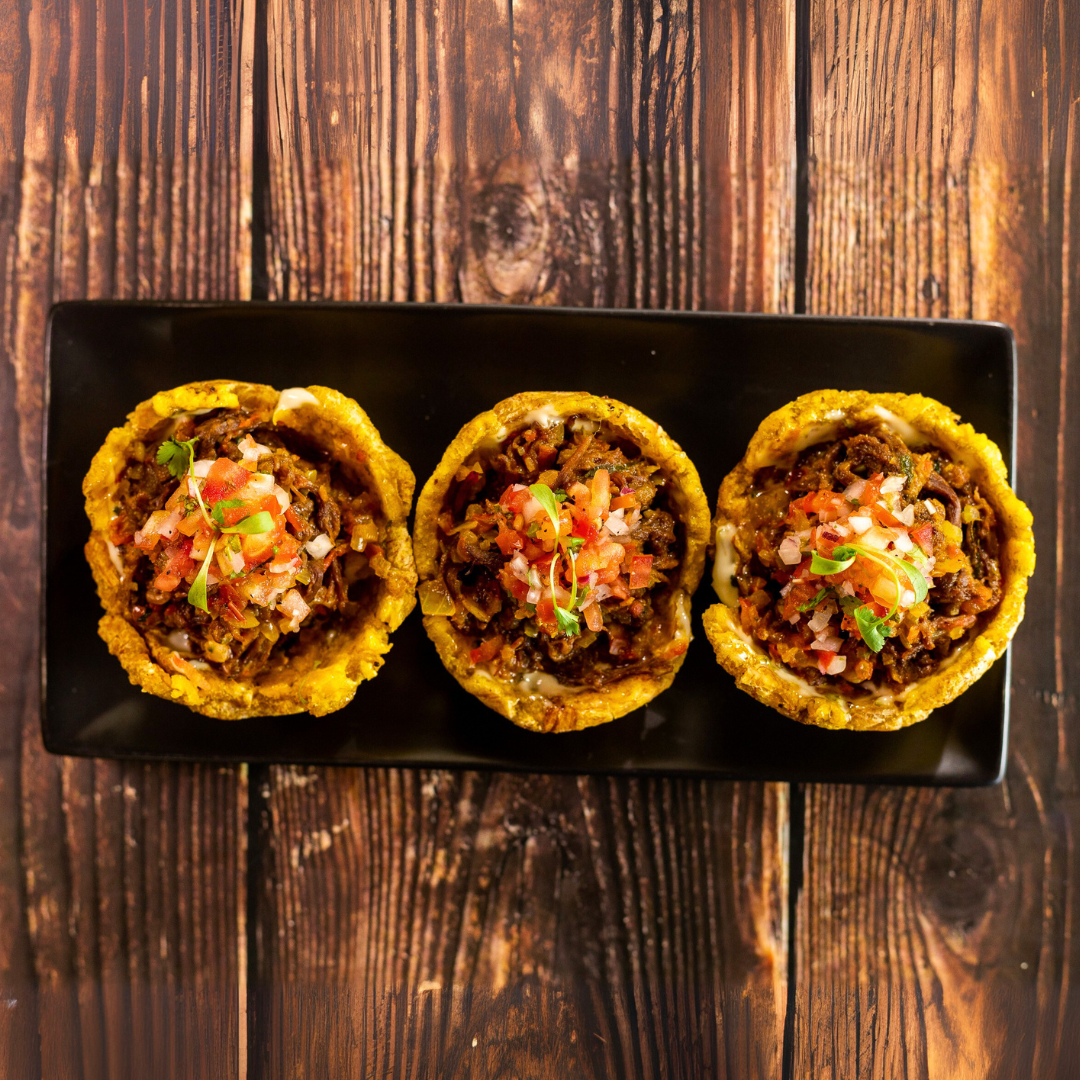 Orden de Chicharrones con Patacones + 2 Órdenes de Tostones con Ropa Vieja + 2 Bebidas por $20 en Carpe Diem Terrace